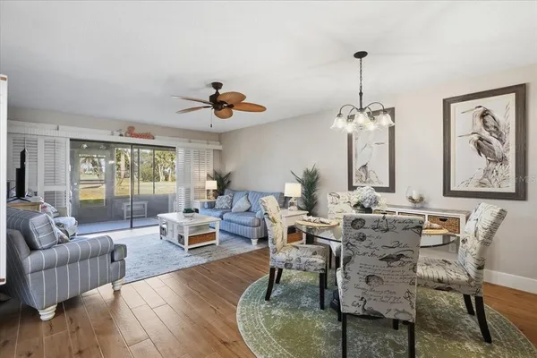 a living room with hardwood floor and balcony