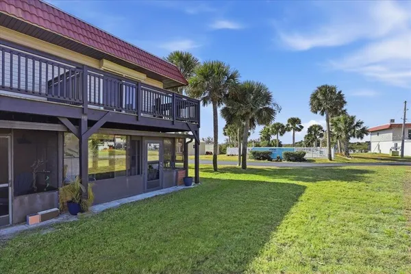 a view of a house with outdoor space and palm tree