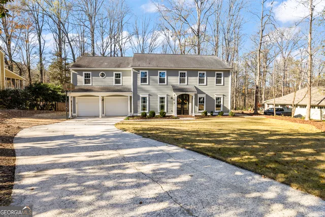 a kitchen with stainless steel appliances granite countertop a sink a stove a refrigerator and cabinets