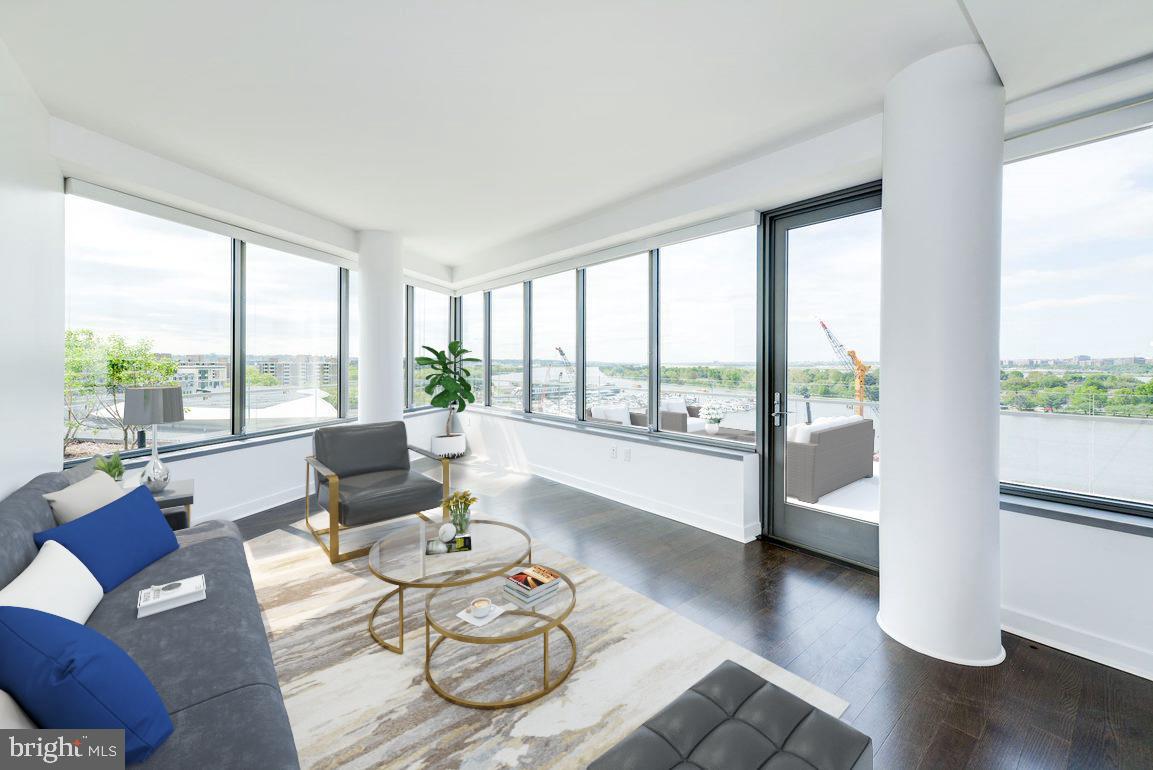 a living room with furniture and floor to ceiling window
