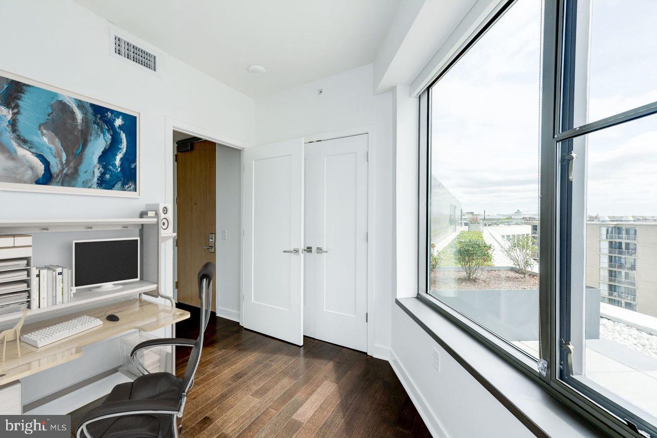 900 7th Street Southwest, Unit PH04 Washington, DC 20024 - Photo 2 of 25 a view of a workspace with furniture and a fireplace