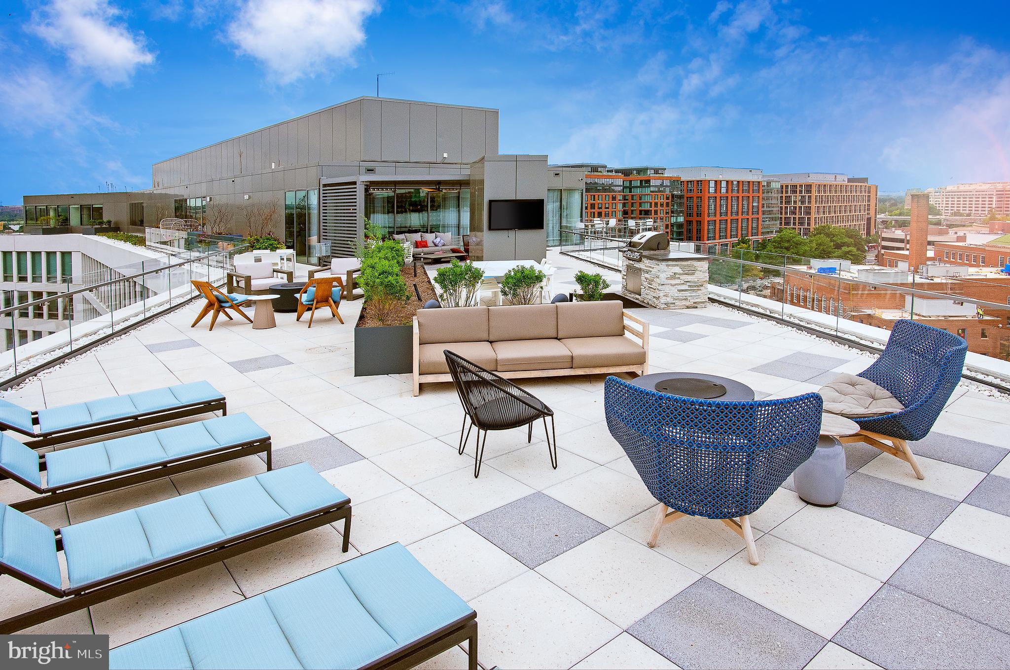 900 7th Street Southwest, Unit PH04 Washington, DC 20024 - Photo 13 of 25 a view of a patio with couches chairs and a potted plant on a table