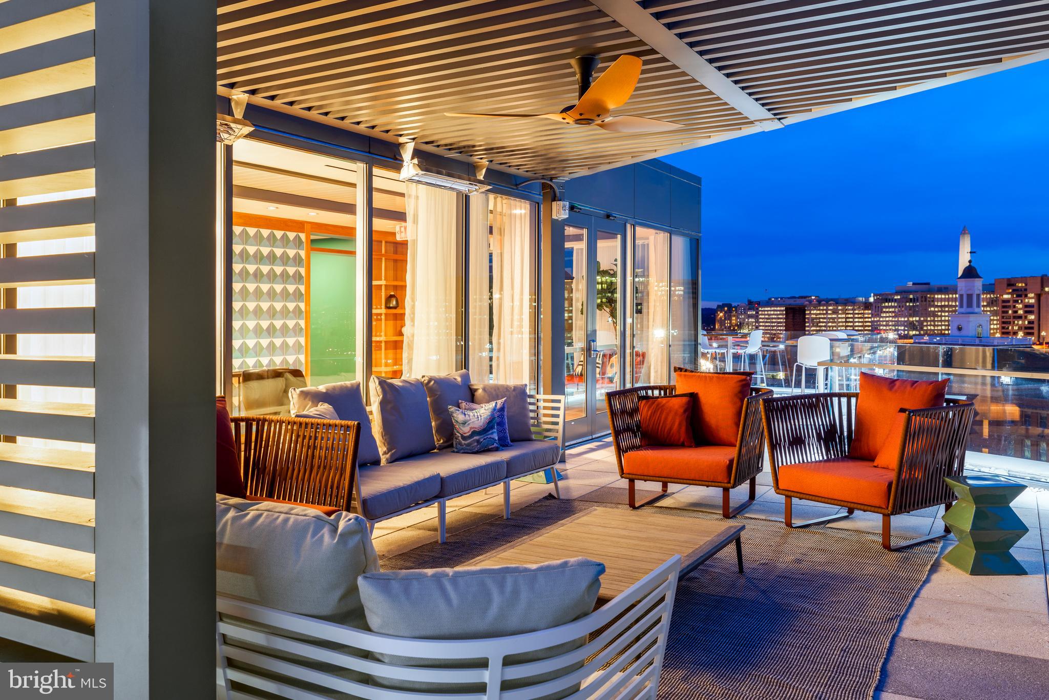 900 7th Street Southwest, Unit PH04 Washington, DC 20024 - Photo 14 of 25 a outdoor living space with furniture and a fireplace