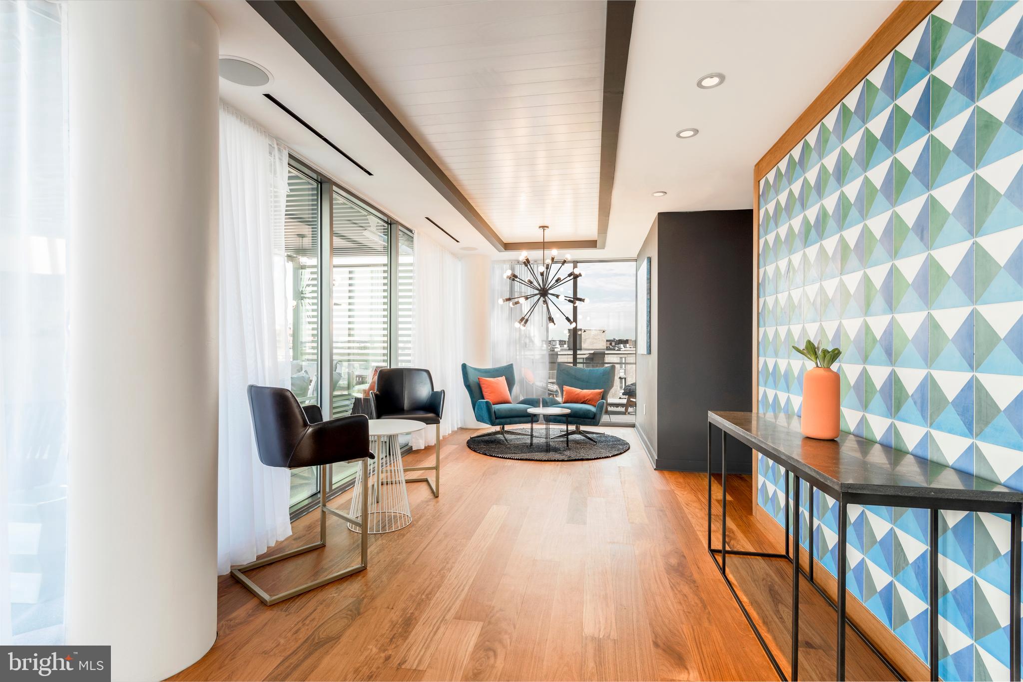 900 7th Street Southwest, Unit PH04 Washington, DC 20024 - Photo 17 of 25 a living room with furniture and a large window