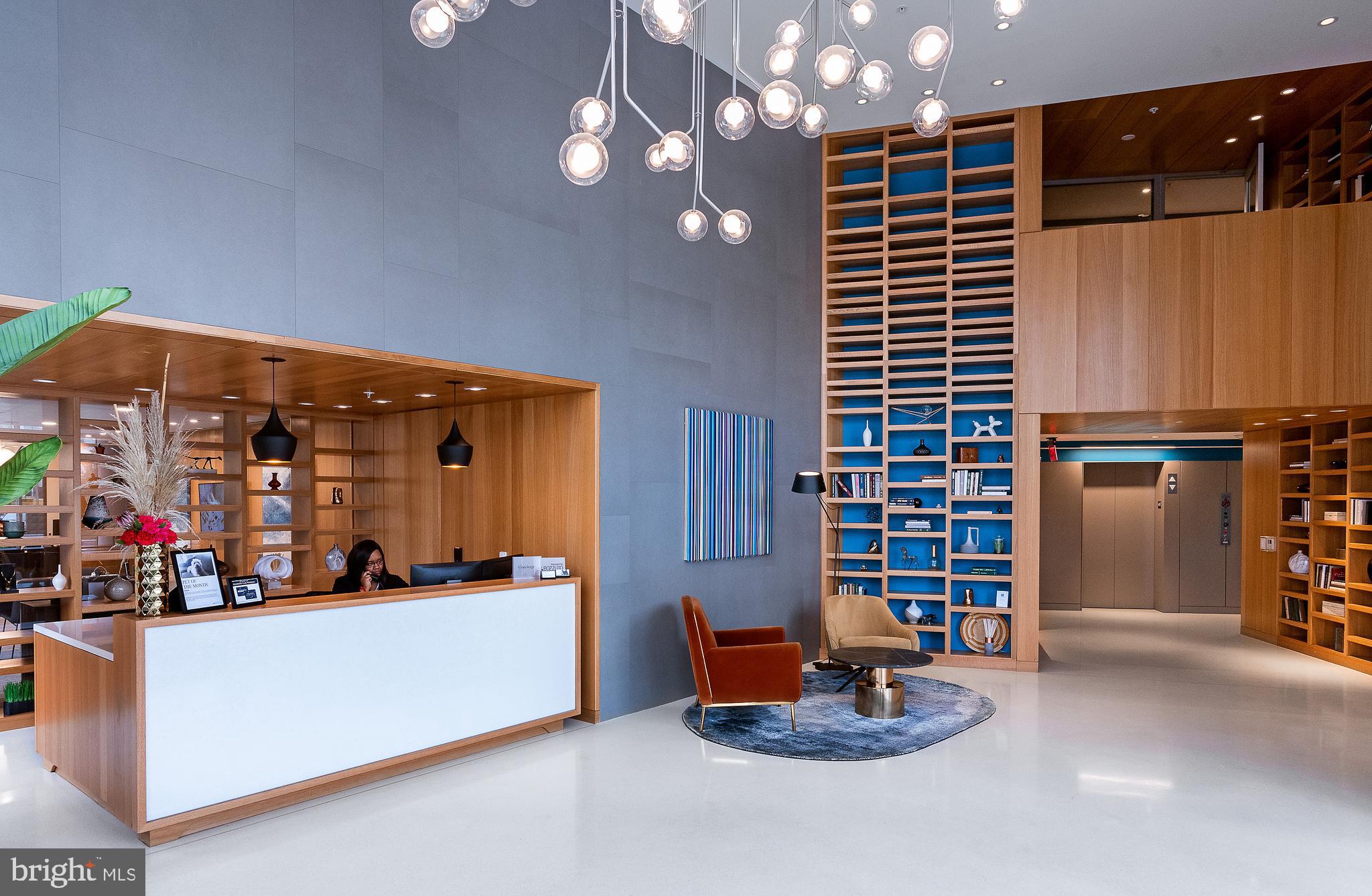 900 7th Street Southwest, Unit PH04 Washington, DC 20024 - Photo 20 of 25 a dining room with furniture and a chandelier