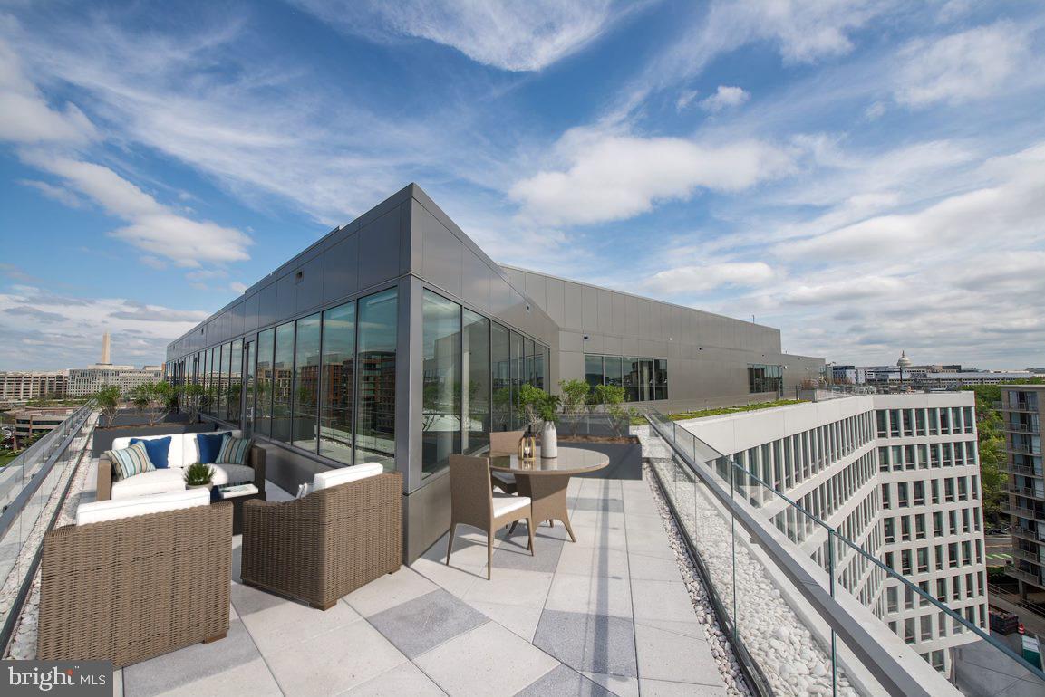 900 7th Street Southwest, Unit PH04 Washington, DC 20024 - Photo 4 of 25 a view of a chair and tables in the balcony