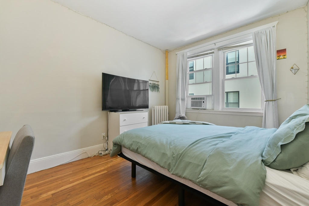 301 Allston Street, Unit 7 Boston, MA 02135 - Photo 14 of 25 a bedroom with a bed tv and a window