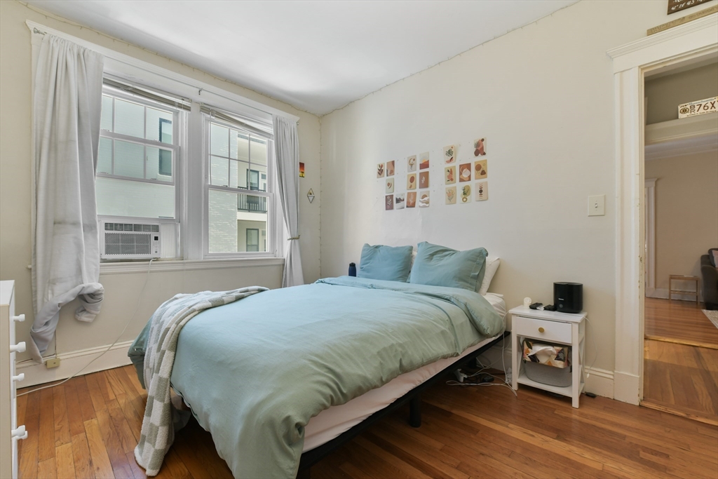 301 Allston Street, Unit 7 Boston, MA 02135 - Photo 15 of 25 a bed sitting in a bedroom next to a window