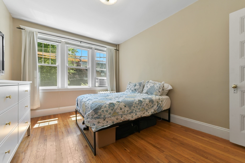 301 Allston Street, Unit 7 Boston, MA 02135 - Photo 17 of 25 a bedroom with a bed and wooden floor