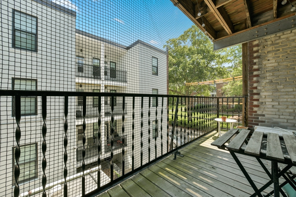 301 Allston Street, Unit 7 Boston, MA 02135 - Photo 19 of 25 a balcony with wooden floor