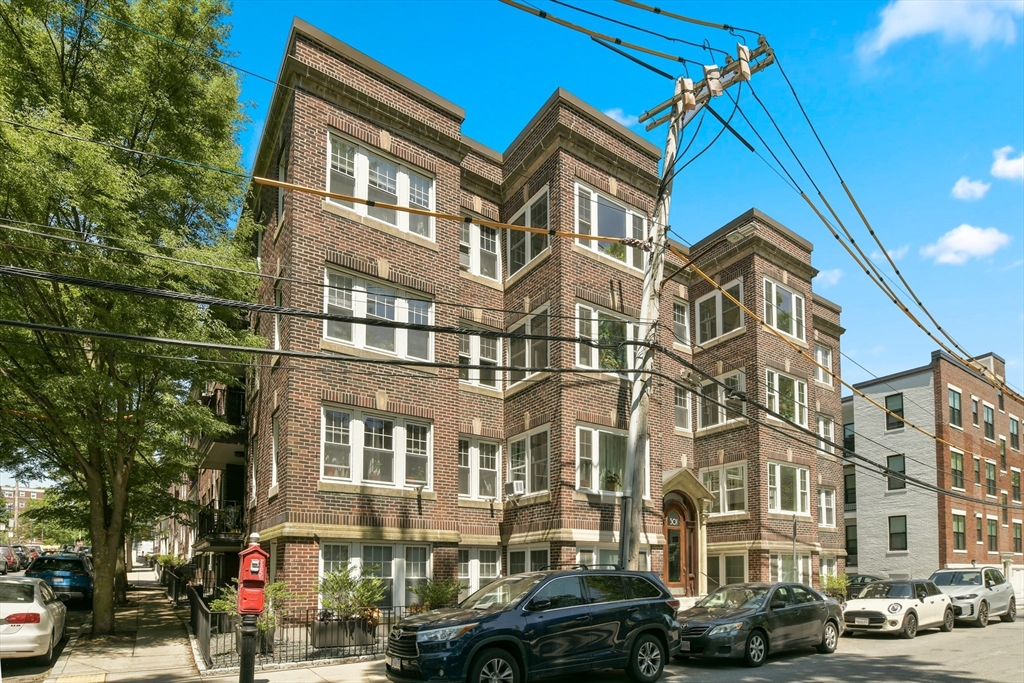 301 Allston Street, Unit 7 Boston, MA 02135 - Photo 2 of 25 a front view of a residential apartment building with a yard