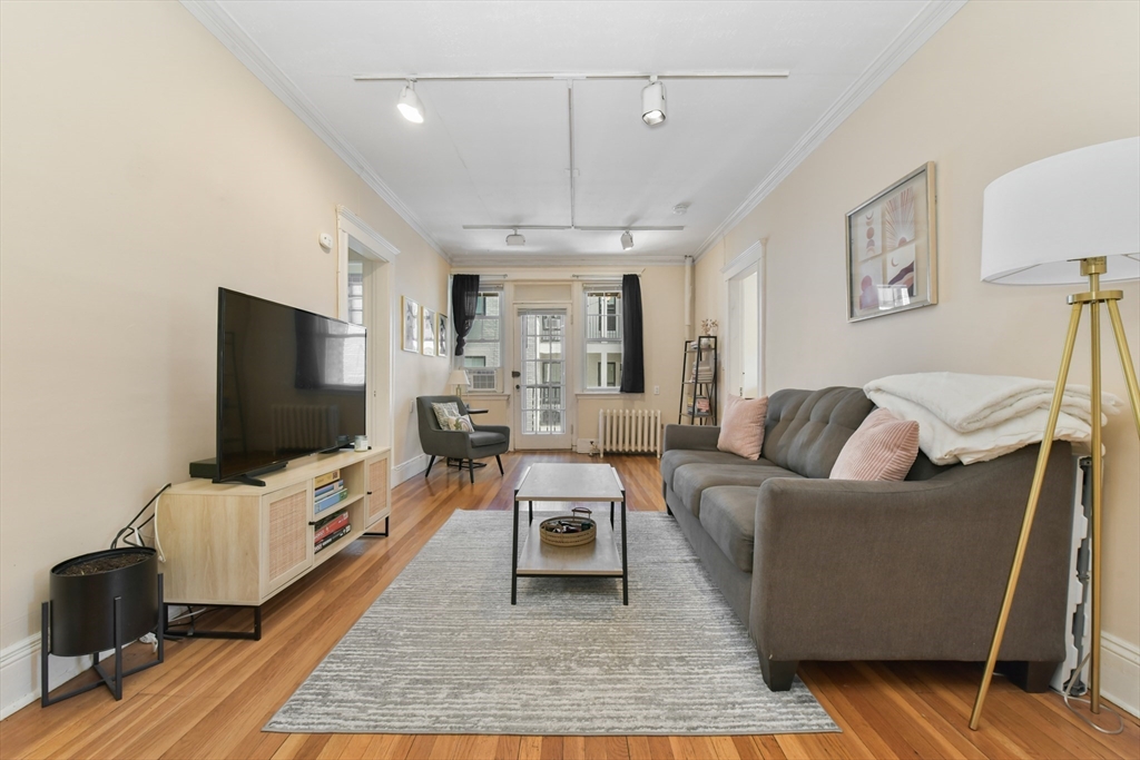 301 Allston Street, Unit 7 Boston, MA 02135 - Photo 4 of 25 a living room with furniture and a flat screen tv