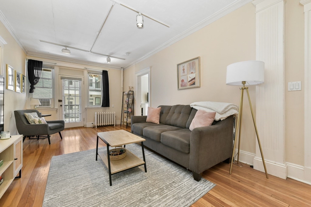 301 Allston Street, Unit 7 Boston, MA 02135 - Photo 5 of 25 a living room with furniture and a wooden floor