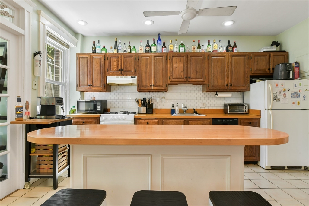 301 Allston Street, Unit 7 Boston, MA 02135 - Photo 8 of 25 a kitchen with stainless steel appliances granite countertop a sink a refrigerator and a stove