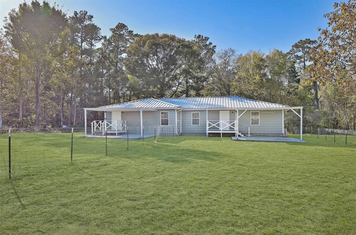 22965 Highway 146 Cleveland, TX 77327 - Photo 1 of 18 a front view of a house with a garden