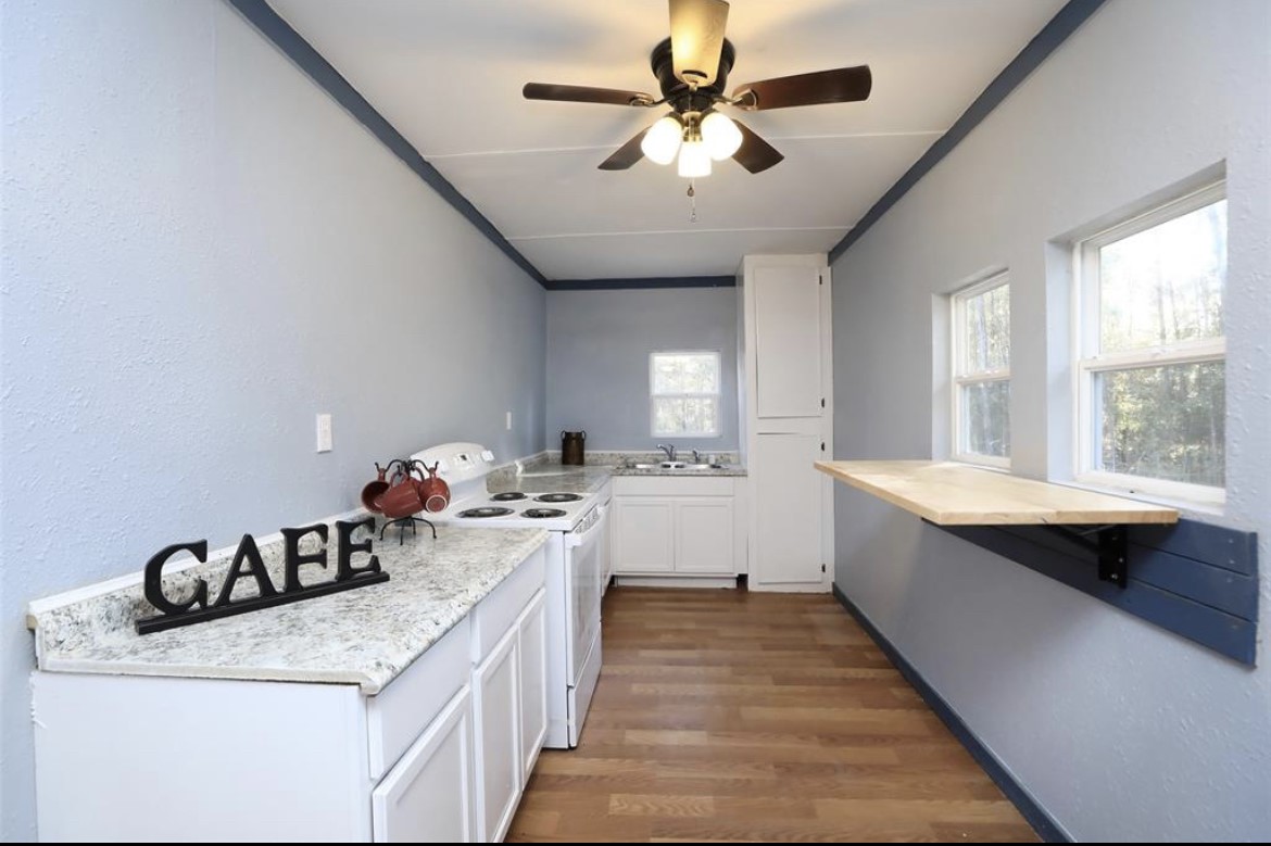 22965 Highway 146 Cleveland, TX 77327 - Photo 15 of 18 a kitchen with a sink appliances and a window