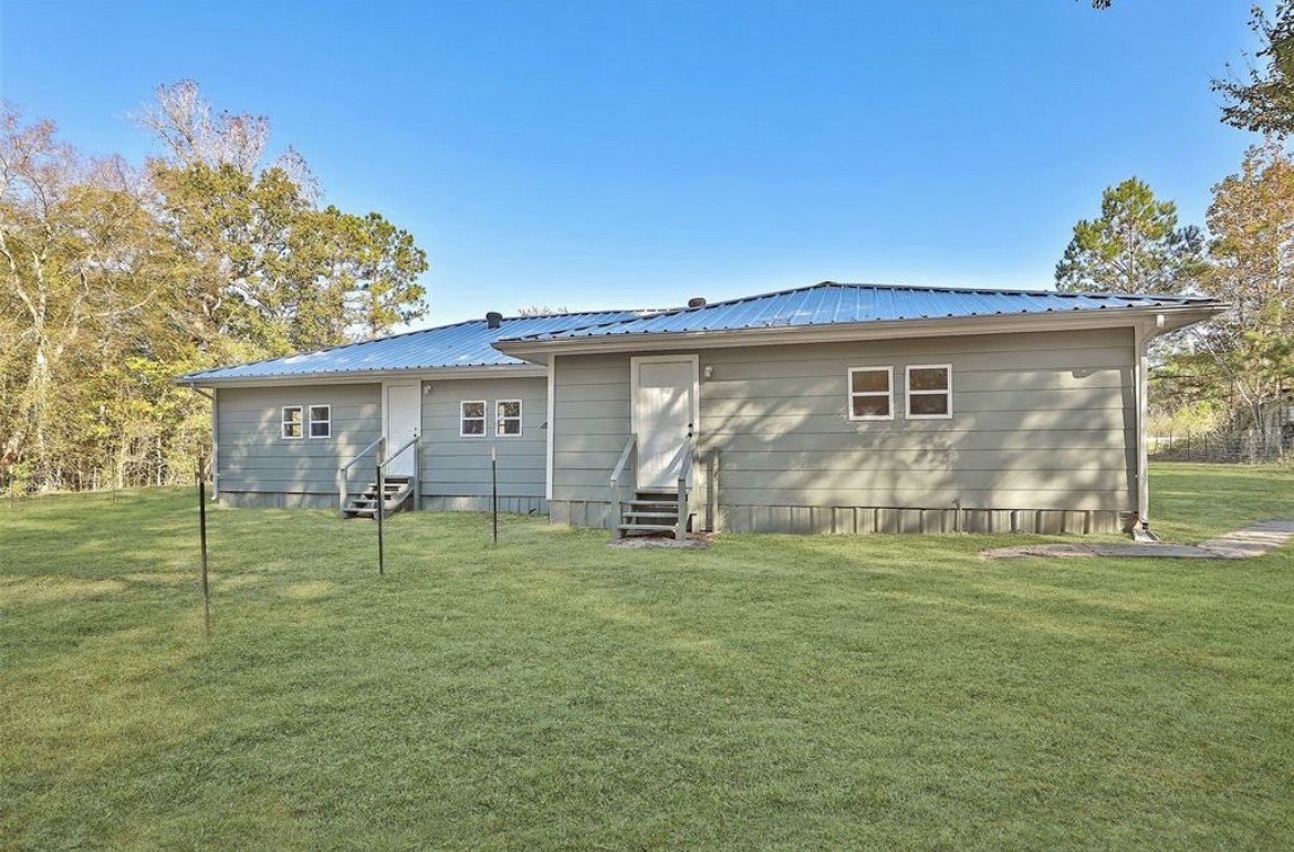 22965 Highway 146 Cleveland, TX 77327 - Photo 16 of 18 a view of a house with a yard