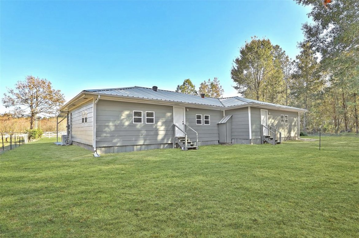 22965 Highway 146 Cleveland, TX 77327 - Photo 17 of 18 a view of a house with a yard