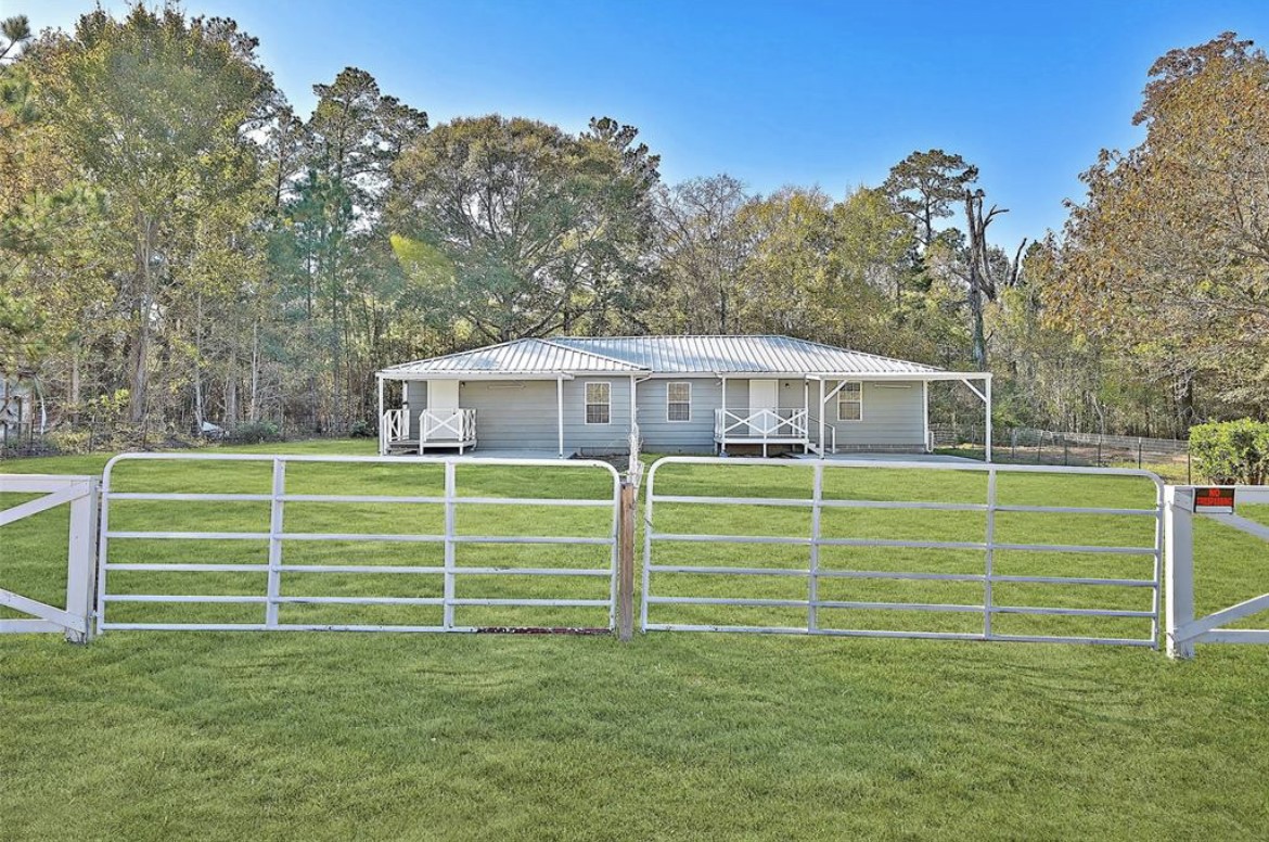 22965 Highway 146 Cleveland, TX 77327 - Photo 2 of 18 a view of a house with a big yard and large trees
