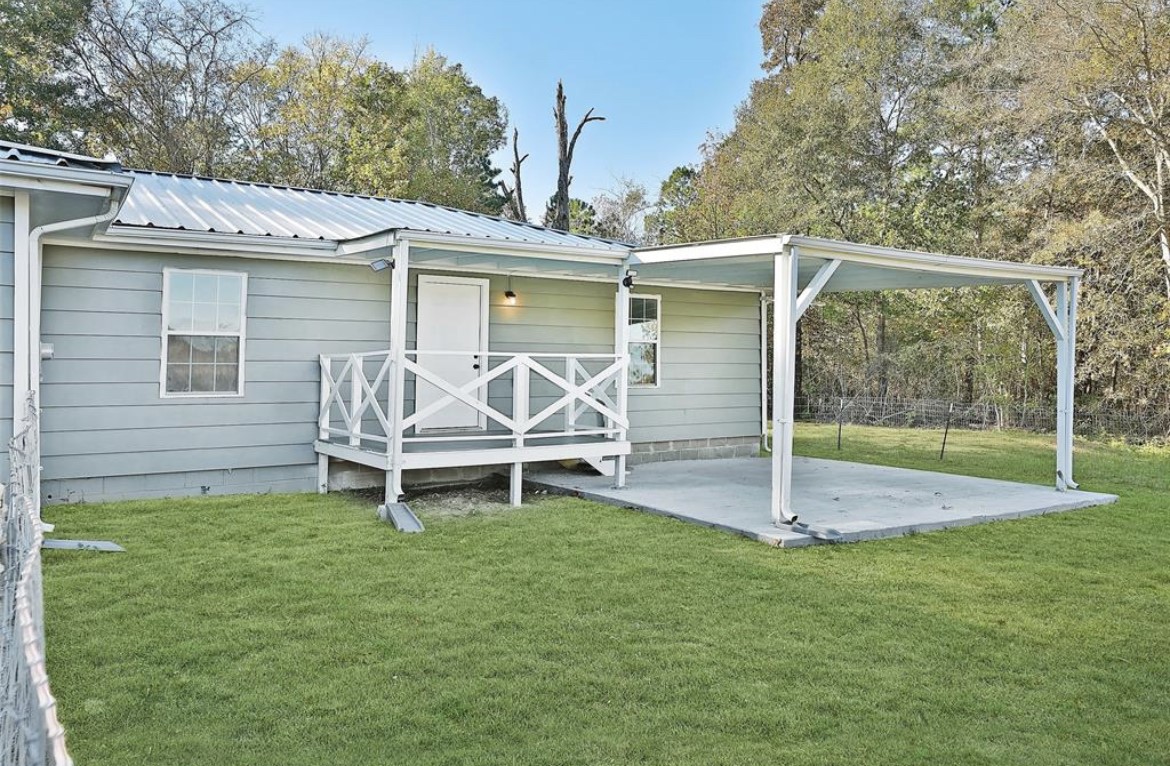 22965 Highway 146 Cleveland, TX 77327 - Photo 3 of 18 a view of a chair and table in backyard of the house