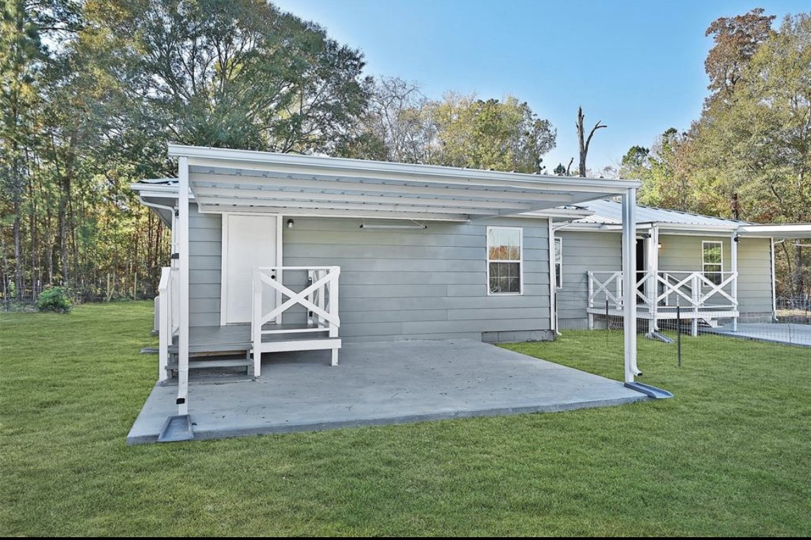 22965 Highway 146 Cleveland, TX 77327 - Photo 4 of 18 a view of a house with a yard and sitting area
