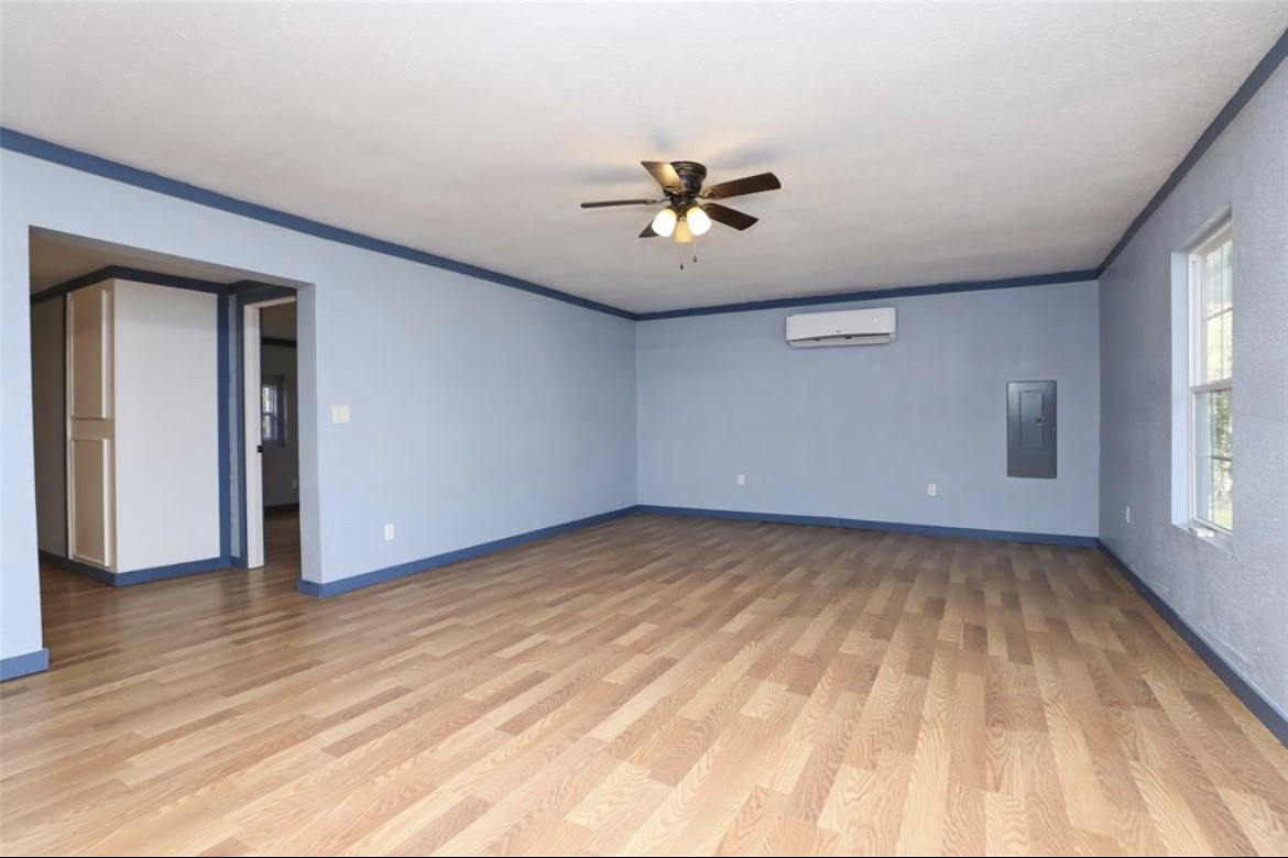 22965 Highway 146 Cleveland, TX 77327 - Photo 5 of 18 a view of a big room with wooden floor and windows in a room