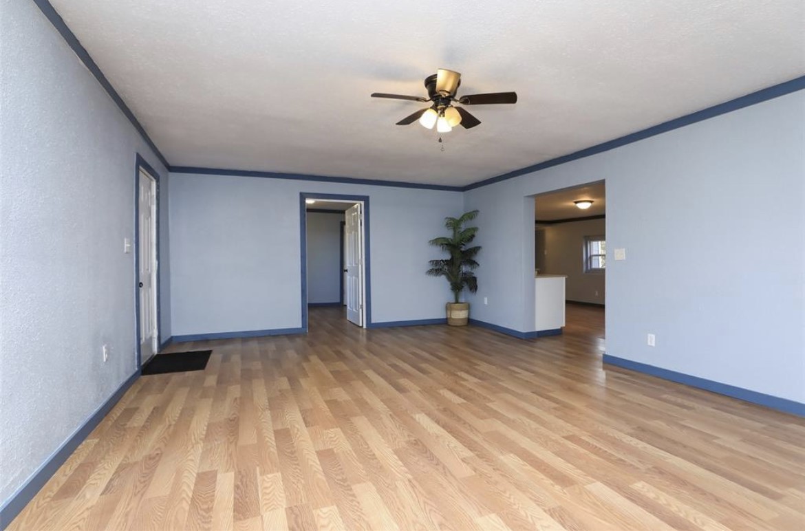 22965 Highway 146 Cleveland, TX 77327 - Photo 6 of 18 a view of empty room with wooden floor and fan