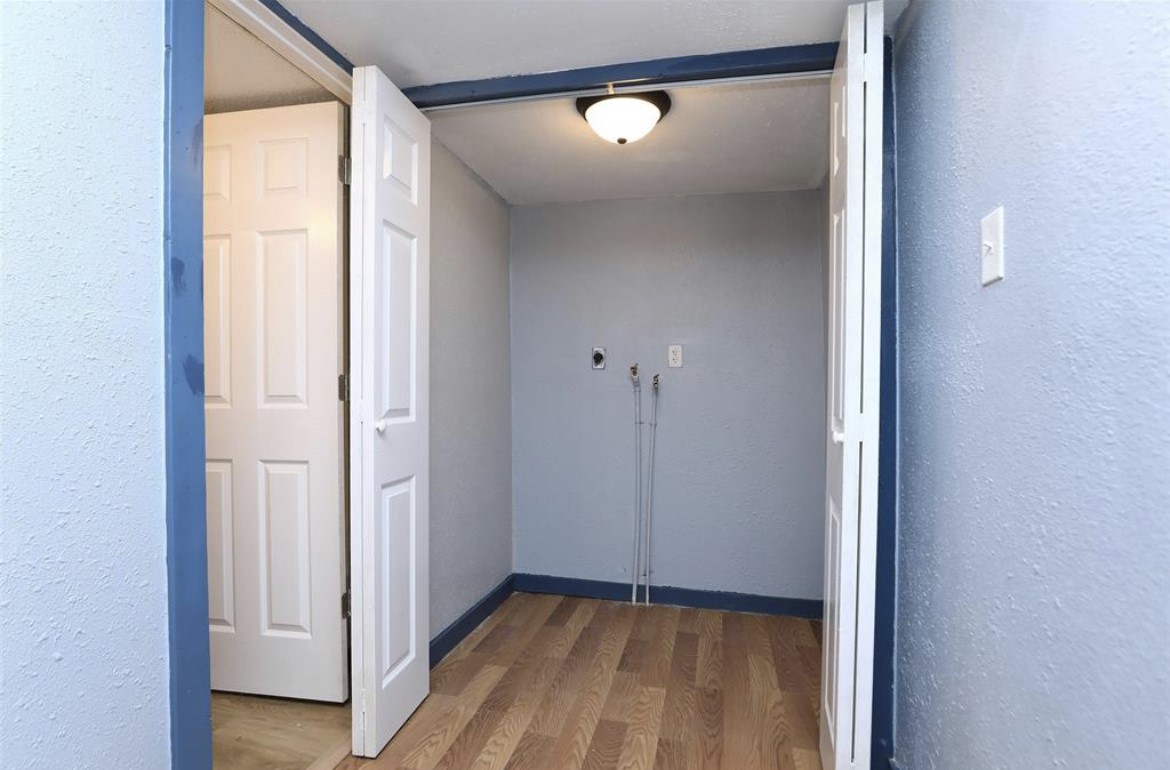 22965 Highway 146 Cleveland, TX 77327 - Photo 9 of 18 a view of a room with wooden floor and sliding door