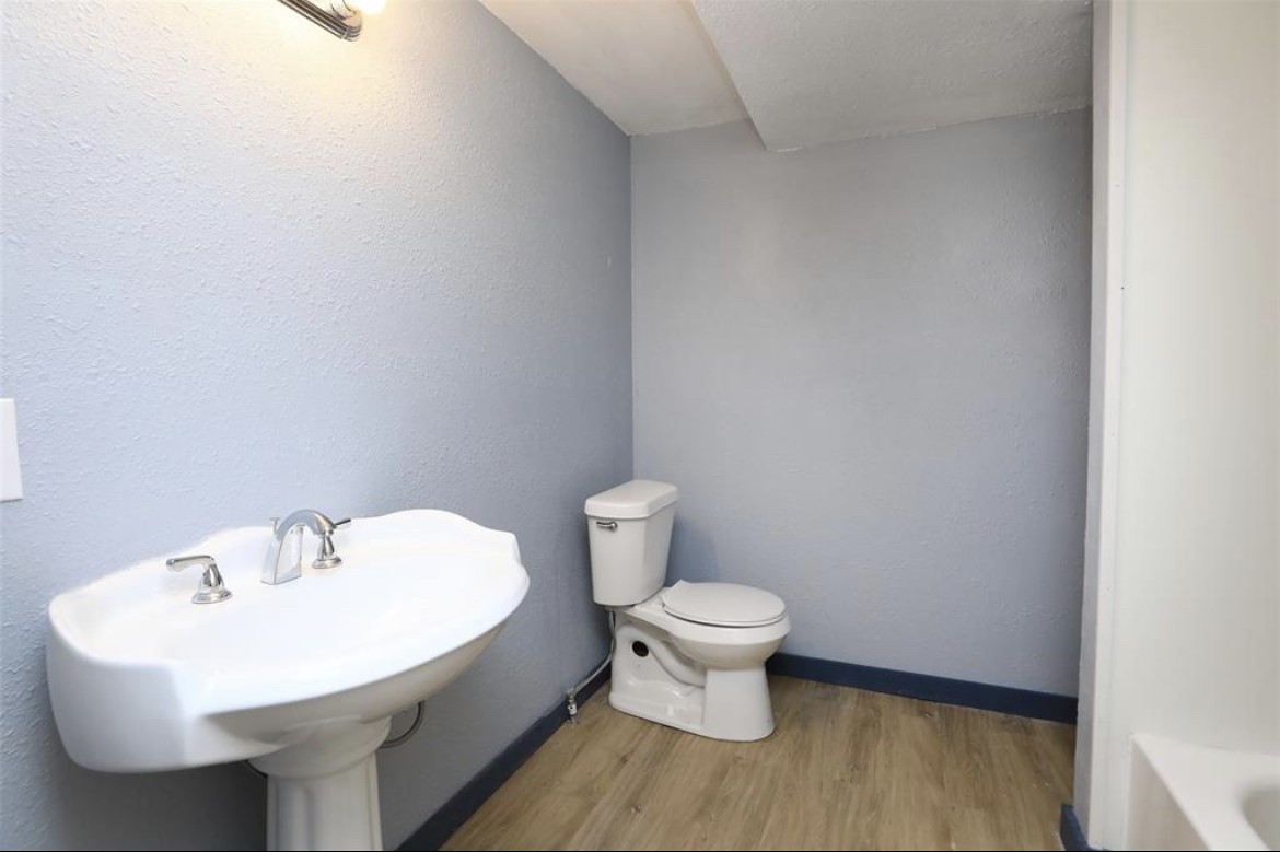 22965 Highway 146 Cleveland, TX 77327 - Photo 10 of 18 a bathroom with a sink and a toilet