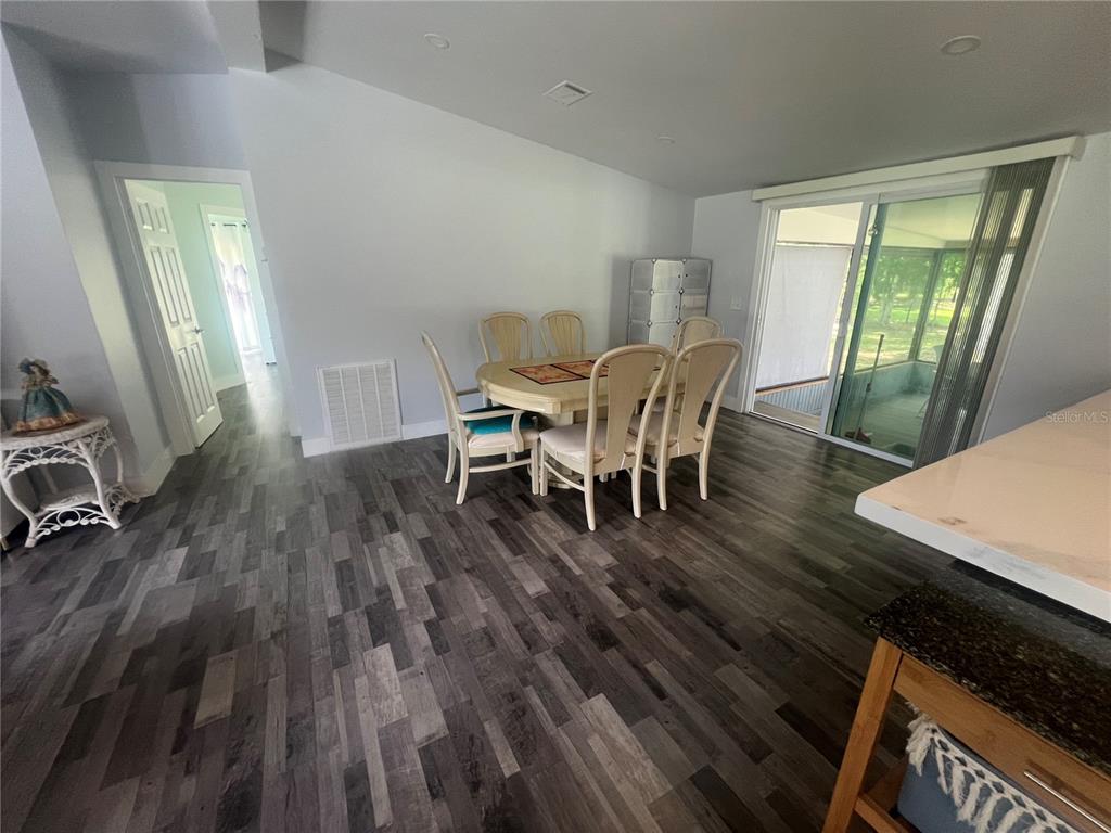5855 Jack Brack Road St. Cloud, FL 34771 - Photo 82 of 86 a view of a dining room with furniture and wooden floor