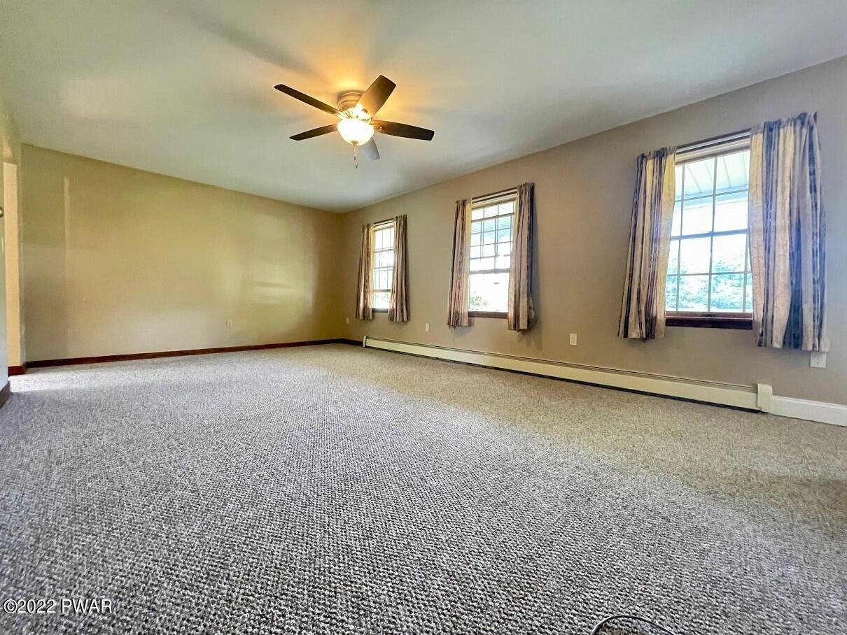 524 Creamton Drive Prompton, PA 18456 - Photo 21 of 57 an empty room with windows and fan