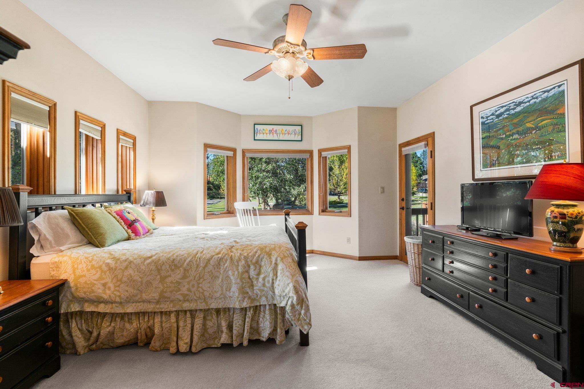 747 Oak Drive Durango, CO 81301 - Photo 17 of 34 a bedroom with a large bed and a chandelier fan