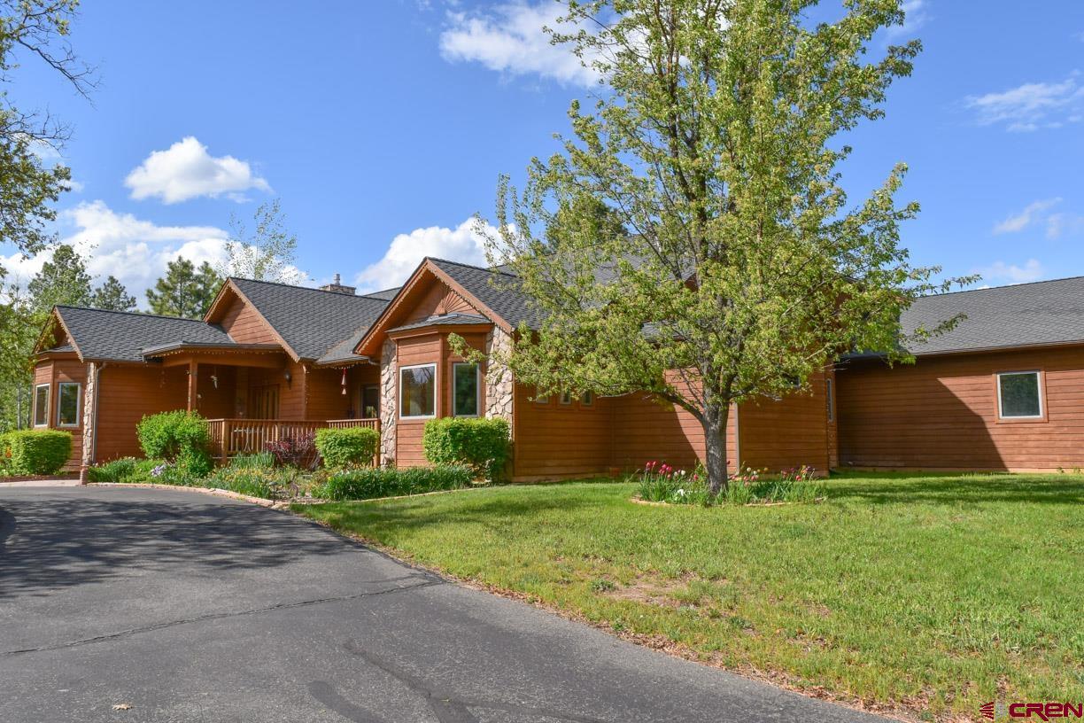 747 Oak Drive Durango, CO 81301 - Photo 2 of 34 a front view of house with yard and trees around