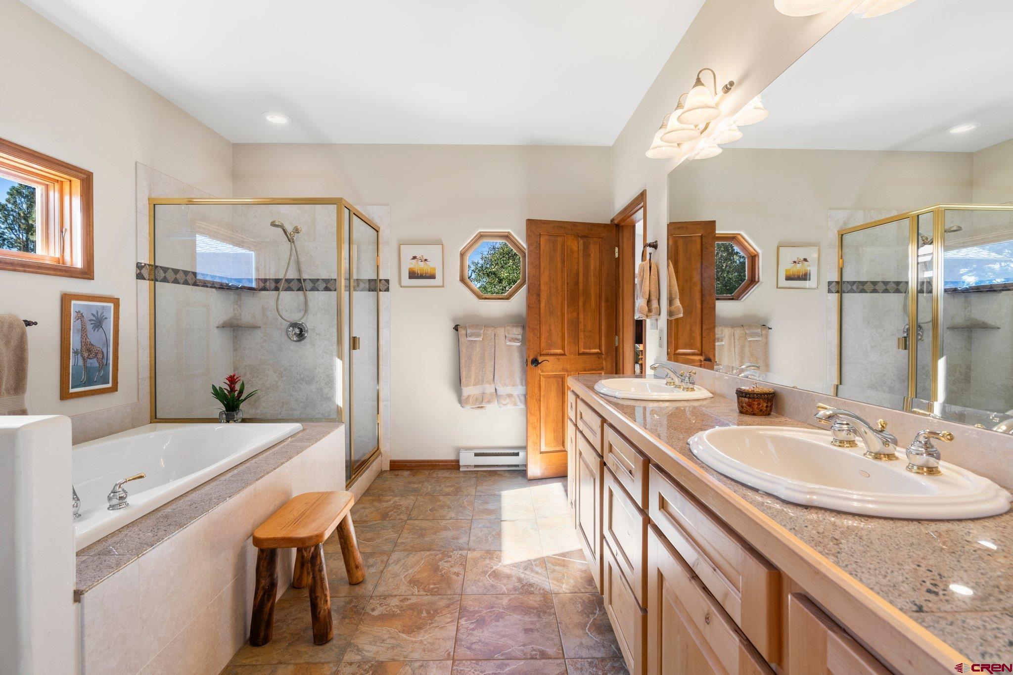 747 Oak Drive Durango, CO 81301 - Photo 22 of 34 a bathroom with a sink a tub and a mirror