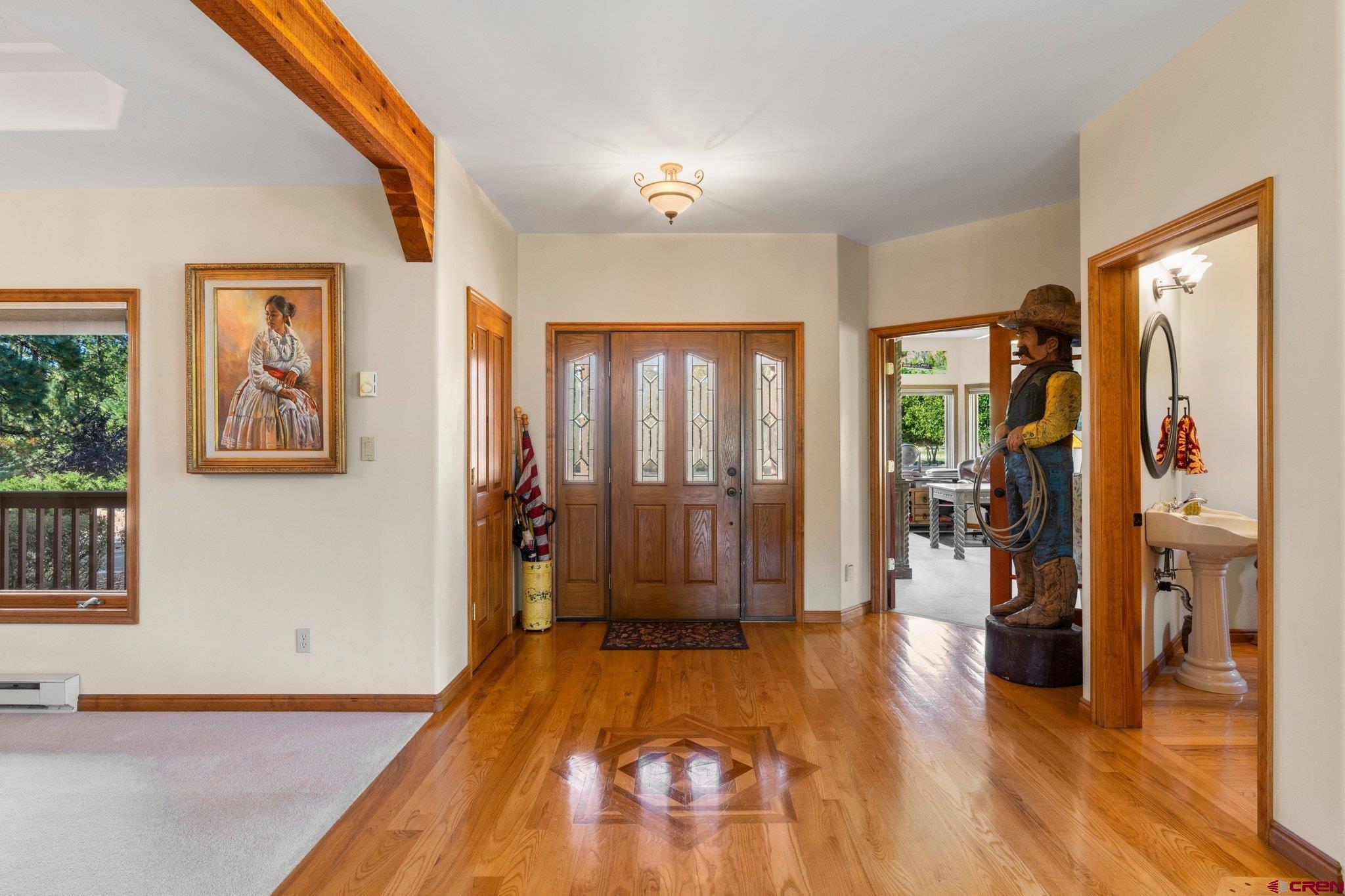 747 Oak Drive Durango, CO 81301 - Photo 24 of 34 a spacious bedroom with a large bed and a chandelier