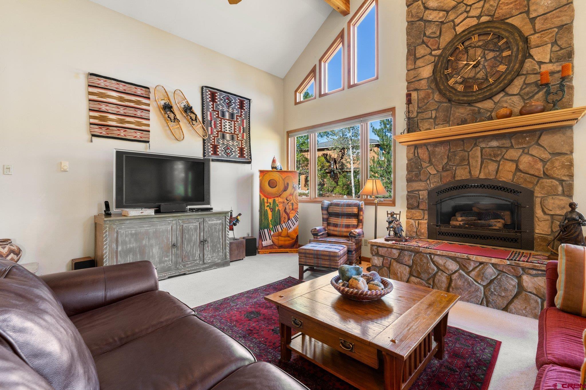 747 Oak Drive Durango, CO 81301 - Photo 3 of 34 a living room with furniture a flat screen tv and a fireplace
