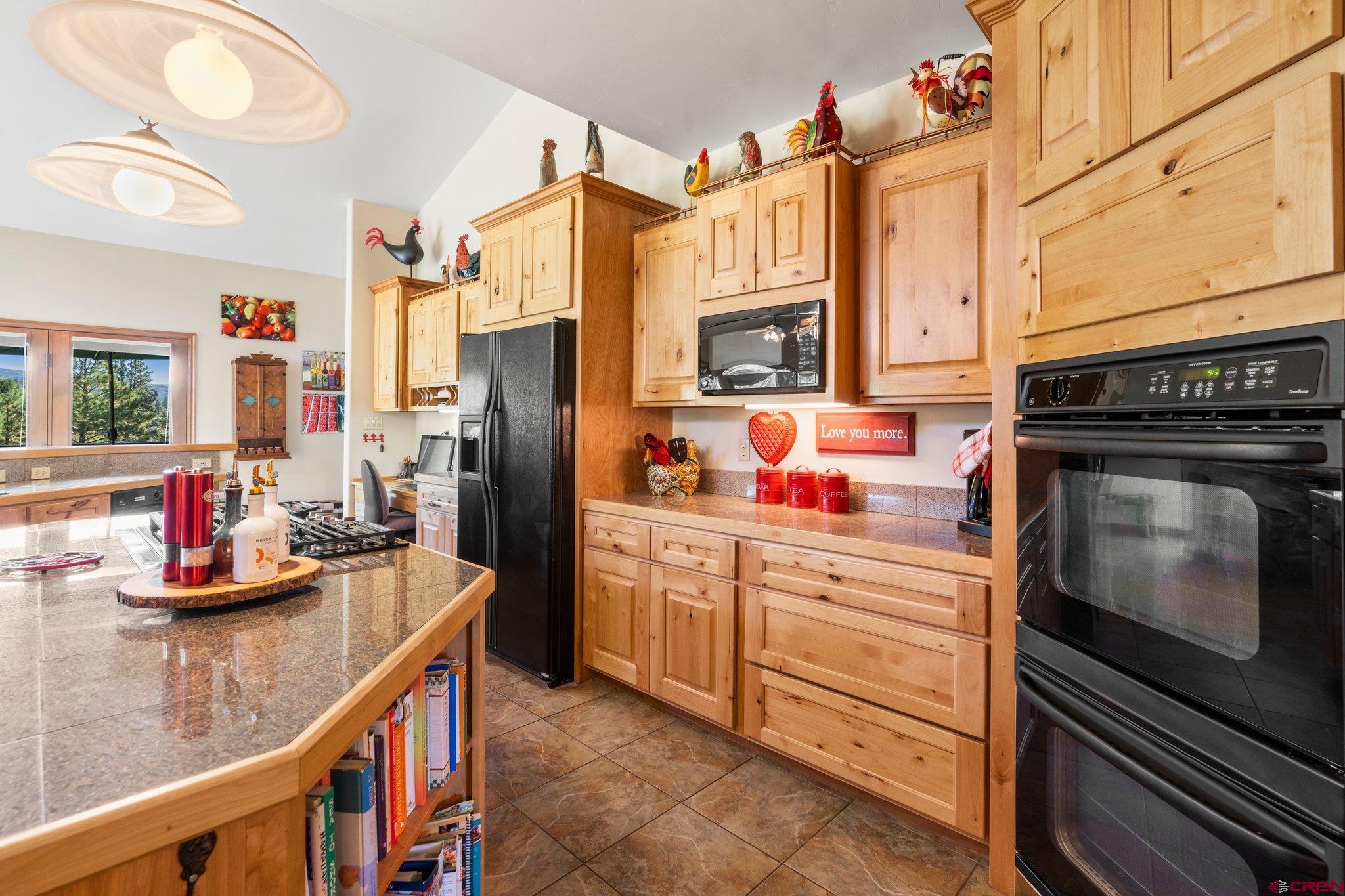 747 Oak Drive Durango, CO 81301 - Photo 6 of 34 a kitchen with stainless steel appliances a stove refrigerator and cabinets