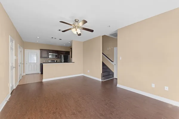 a view of a kitchen with a sink and a chandelier fan