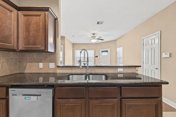 a sink with granite countertop a sink and cabinets
