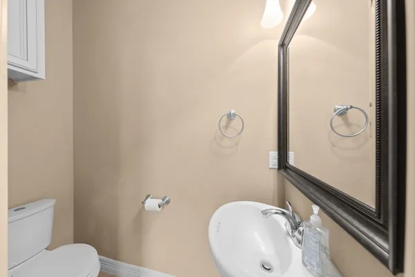 a bathroom with a sink mirror vanity and toilet