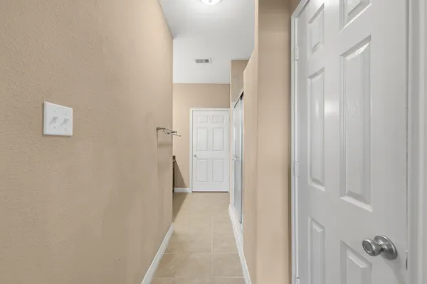 a view of a hallway with closet and wooden floor
