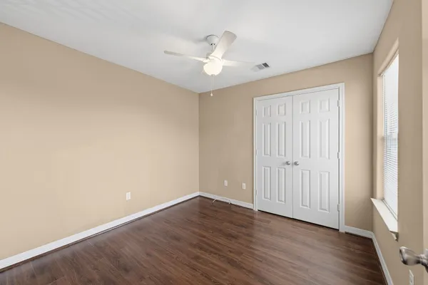 a view of an empty room with wooden floor