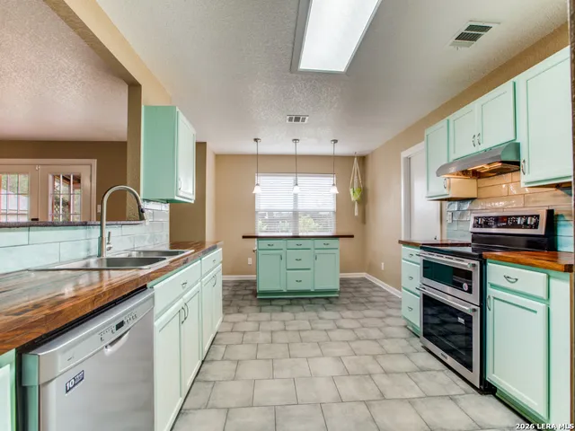 a kitchen with a sink stove and cabinets
