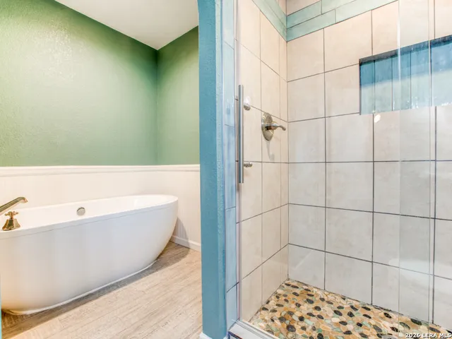 a bathroom with a bathtub and shower