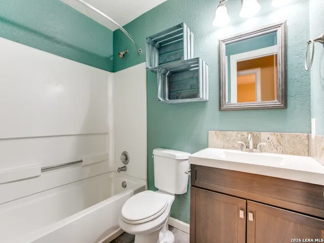 a bathroom with a toilet a sink and a bathtub