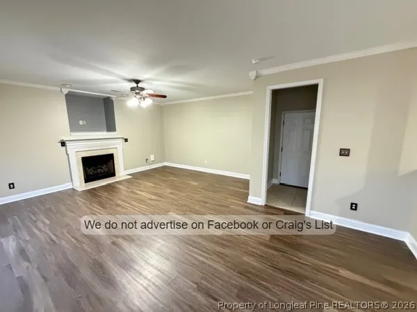 a view of a kitchen with wooden floor and a ceiling fan