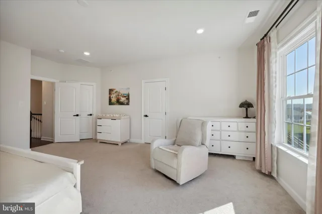 a spacious bedroom with a bed and a window