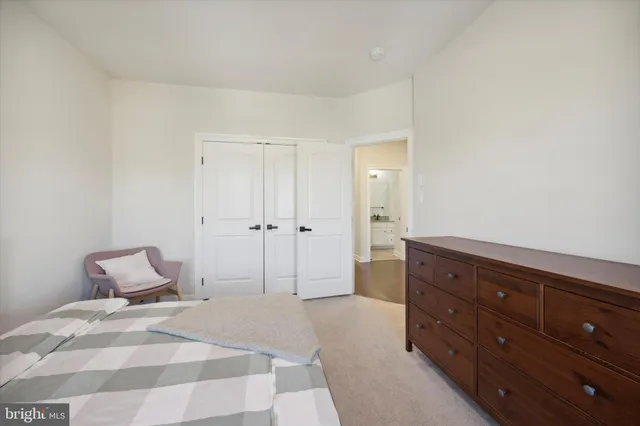 a bedroom with a bed and a dresser