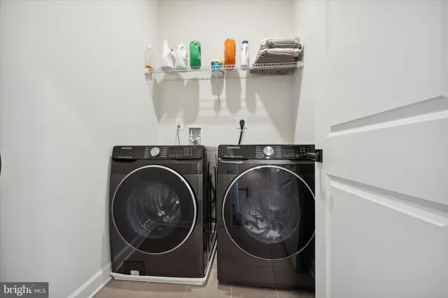 a utility room with sink dryer and washer