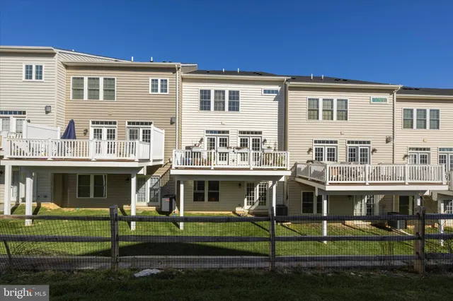 a front view of a residential apartment building with a yard